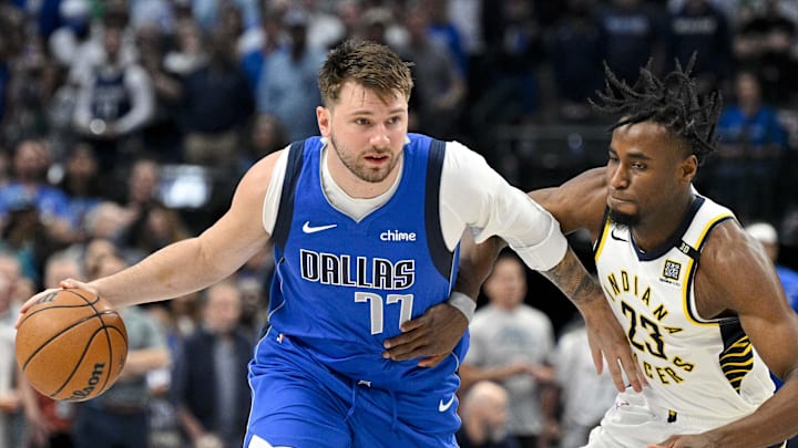 Mar 5, 2024; Dallas, Texas, USA; Dallas Mavericks guard Luka Doncic (77) looks to move the ball past Indiana Pacers forward Aaron Nesmith (23) during the first quarter at the American Airlines Center. Mandatory Credit: Jerome Miron-Imagn Images Mar 5, 2024; Dallas, Texas, USA; Dallas Mavericks guard Luka Doncic (77) looks to move the ball past Indiana Pacers forward Aaron Nesmith (23) during the first quarter at the American Airlines Center. Mandatory Credit: Jerome Miron-Imagn Images