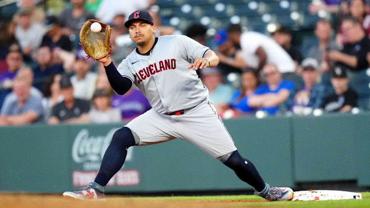 May 29, 2024; Denver, Colorado, USA; Cleveland Guardians first base Josh Naylor (22) fields the ball during the fifth inning against the Colorado Rockies at Coors Field. Mandatory Credit: Ron Chenoy-Imagn Images