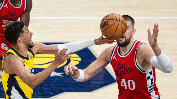 Feb 23, 2025; Indianapolis, Indiana, USA;  Indiana Pacers guard Tyrese Haliburton (0) shoots against LA Clippers center Ivica Zubac (40) in the first half at Gainbridge Fieldhouse. Mandatory Credit: Trevor Ruszkowski-Imagn Images