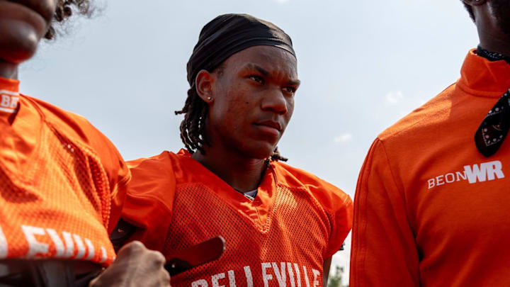 Senior Elijah Dotson, 17, listens to a coach's advice during a team practice at Belleville High School football field in Belleville on Wednesday, Aug. 14, 2024.