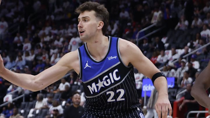Apr 22, 2026; Detroit, Michigan, USA; Detroit Pistons guard Cade Cunningham (2) dribbles defended by Orlando Magic center Wendell Carter Jr. (34) and forward Franz Wagner (22) in the second half during game two of the first round of the 2026 NBA Playoffs at Little Caesars Arena. Mandatory Credit: Rick Osentoski-Imagn Images