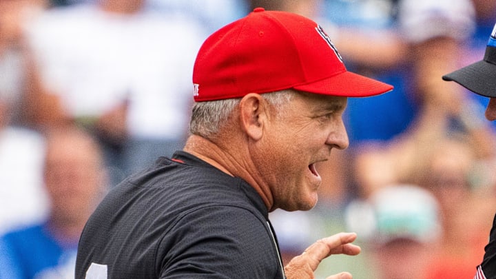 Jun 15, 2024; Omaha, NE, USA; NC State Wolfpack head coach Elliott Avent talks with an official during the seventh inning against the Kentucky Wildcats at Charles Schwab Field Omaha. Mandatory Credit: Dylan Widger-Imagn Images