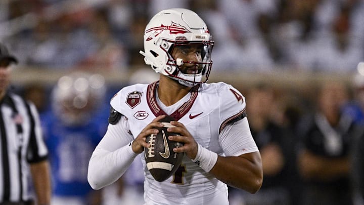 Sep 28, 2024; Dallas, Texas, USA; Florida State Seminoles quarterback DJ Uiagalelei (4) rolls back to pass against the Southern Methodist Mustangs during the second quarter at Gerald J. Ford Stadium. Mandatory Credit: Jerome Miron-Imagn Images