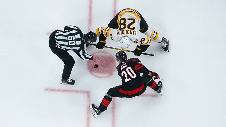 Oct 27, 2026; Raleigh, North Carolina, USA; Carolina Hurricanes center Sebastian Aho (20) and Boston Bruins center Elias Lindholm (28) take a face-off during the second period at Lenovo Center.  Mandatory Credit: James Guillory-Imagn Images