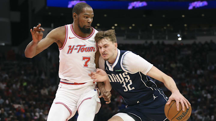 Jan 31, 2026; Houston, Texas, USA; Dallas Mavericks forward Cooper Flagg (32) drives with the ball as Houston Rockets forward Kevin Durant (7) defends during the third quarter at Toyota Center. Mandatory Credit: Troy Taormina-Imagn Images