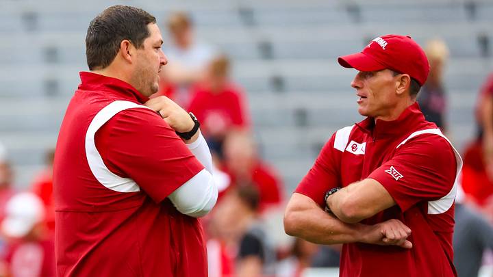Former Oklahoma Sooners offensive coordinator Jeff Lebby speaks with head coach Brent Venables before the game against the Nebraska Cornhuskers at Memorial Stadium. 