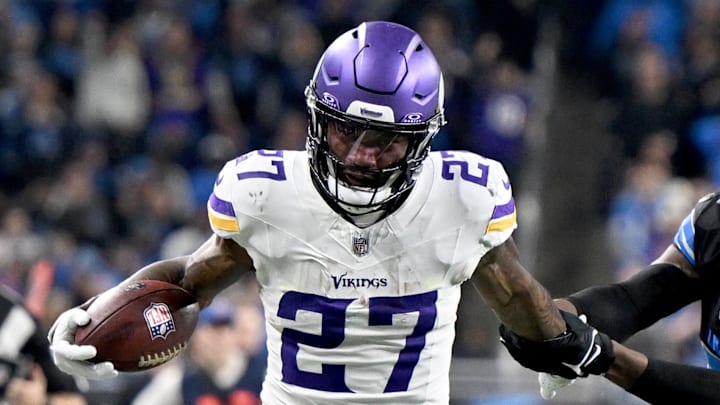 Jan 5, 2025; Detroit, Michigan, USA; Minnesota Vikings running back Cam Akers (27) tries to keep Detroit Lions safety Kerby Joseph (31) at bay as he runs up the sidelines in the third quarter at Ford Field.