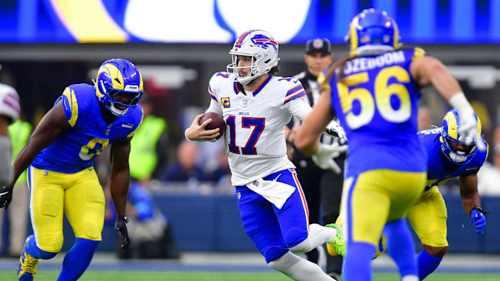 Dec 8, 2024; Inglewood, California, USA; Buffalo Bills quarterback Josh Allen (17) runs the ball against the Los Angeles Rams defense during the second half at SoFi Stadium. Mandatory Credit: Gary A. Vasquez-Imagn Images