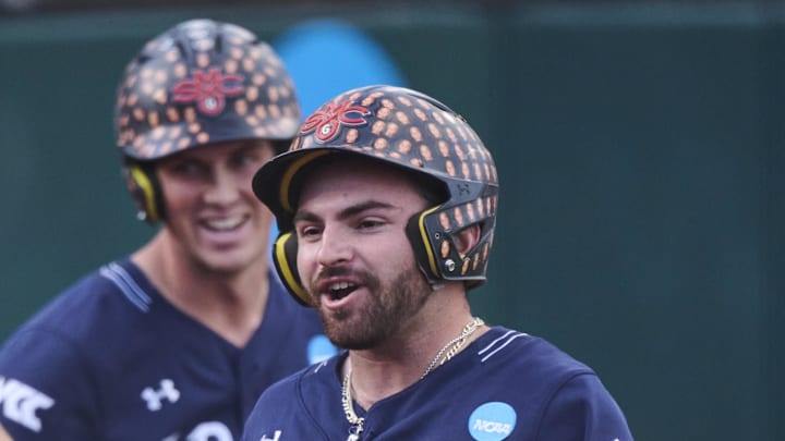 Saint Mary's outfielder Aiden Taurek (right) celebrates after a home run in an NCAA regional game against USC on May 31 at Goss Stadium.\