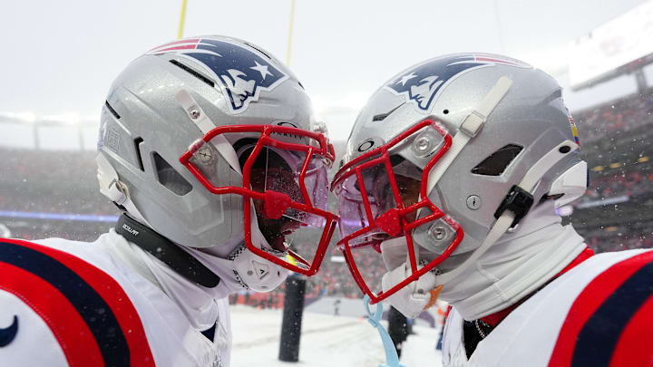Jan 25, 2026; Denver, CO, USA;  New England Patriots cornerback Christian Gonzalez (0) and cornerback Carlton Davis III (7)  react after an interception during the 2026 AFC Championship Game at Empower Field at Mile High. Mandatory Credit: Ron Chenoy-Imagn Images