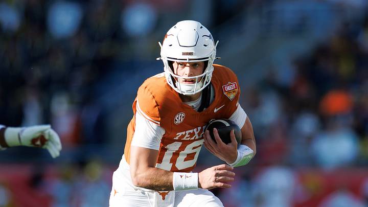 Texas Longhorns quarterback Arch Manning (16) runs with the ball against the Michigan Wolverines during the first half at Camping World Stadium. Texas Longhorns quarterback Arch Manning (16) runs with the ball against the Michigan Wolverines during the first half at Camping World Stadium.