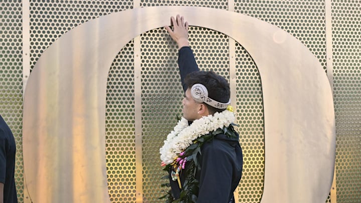 Oct 26, 2024; Eugene, Oregon, USA; Oregon Ducks quarterback Dillon Gabriel (8) runs his hand over a metal shaped O with teammates before a game against the Illinois Fighting Illini at Autzen Stadium. Mandatory Credit: Troy Wayrynen-Imagn Images