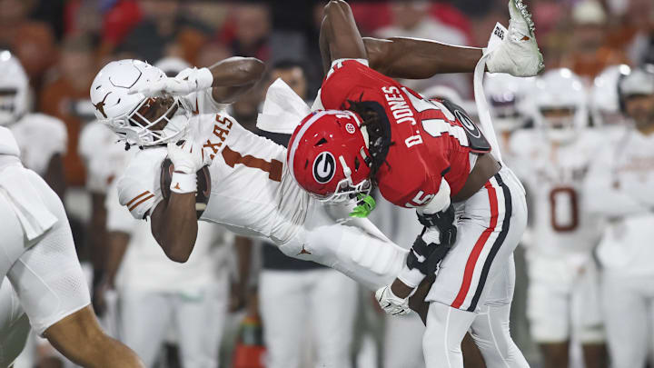 Georgia Bulldogs defensive back Demello Jones tackles Texas Longhorns wide receiver Ryan Wingo in the first half at Sanford Stadium.