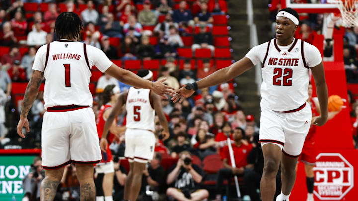 Dec 6, 2025; Raleigh, North Carolina, USA; NC State Wolfpack forward Darrion Williams (1) and forward Ven-Allen Lubin (22) high five during the second half of the game against the Liberty Flames at Lenovo Center. Mandatory Credit: Jaylynn Nash-Imagn Images
