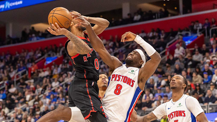 Mar 31, 2026; Detroit, Michigan, USA; Toronto Raptors A.J. Lawson (0) drives to the basket for two points as Detroit Pistons Caris LeVert (8) defends during the second half at Little Caesars Arena. Mandatory Credit: David Reginek-Imagn Images