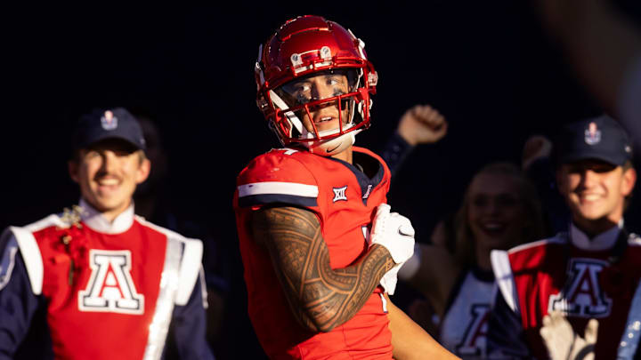 Nov 30, 2024; Tucson, Arizona, USA; Arizona Wildcats wide receiver Tetairoa McMillan (4) celebrates a touchdown against the Arizona State Sun Devils in the second half during the Territorial Cup at Arizona Stadium. Mandatory Credit: Mark J. Rebilas-Imagn Images Nov 30, 2024; Tucson, Arizona, USA; Arizona Wildcats wide receiver Tetairoa McMillan (4) celebrates a touchdown against the Arizona State Sun Devils in the second half during the Territorial Cup at Arizona Stadium. Mandatory Credit: Mark J. Rebilas-Imagn Images