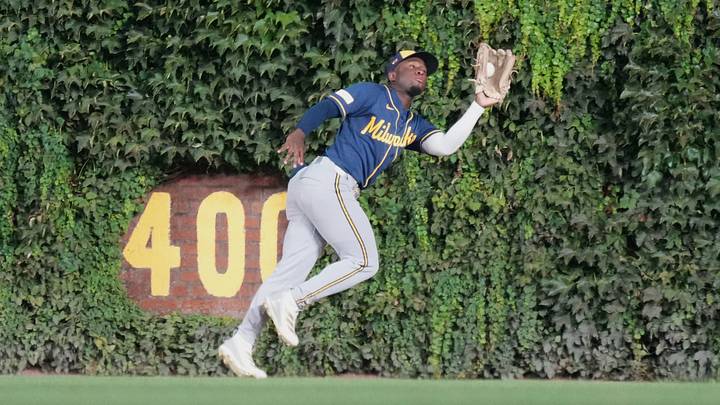 Sep 2, 2026; Chicago, Illinois, USA;  Milwaukee Brewers center fielder Luis Lara (18) makes a catch on Chicago Cubs left fielder Ian Happ (not pictured) during the eighth inning at Wrigley Field.  Mandatory Credit: David Banks-Imagn Images