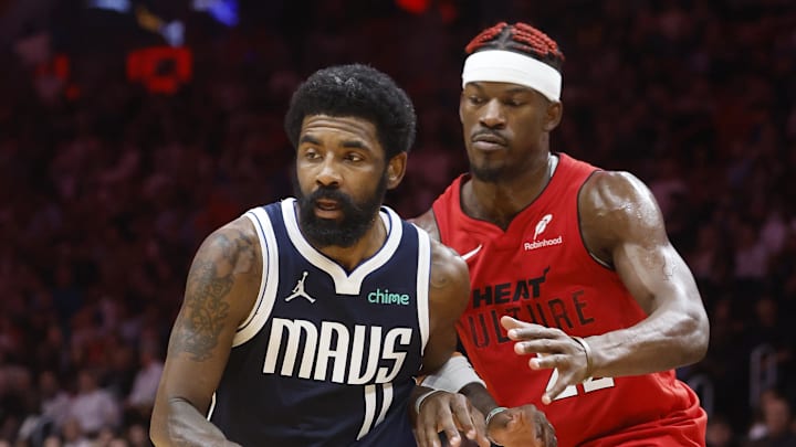 Nov 24, 2024; Miami, Florida, USA;  Miami Heat forward Jimmy Butler (22) defends Dallas Mavericks guard Kyrie Irving (11) during overtime at Kaseya Center. Mandatory Credit: Rhona Wise-Imagn Images
