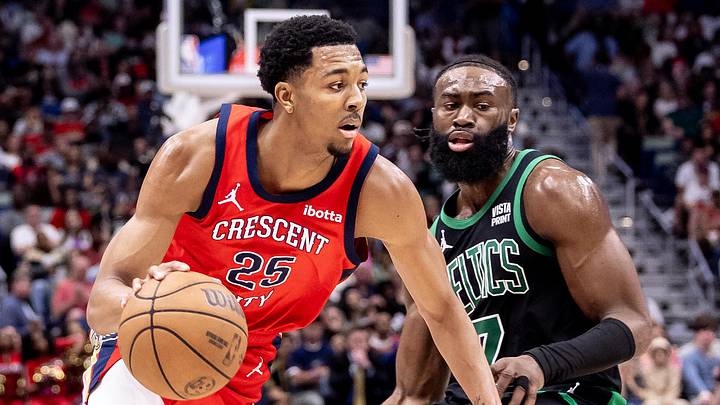Mar 30, 2024; New Orleans, Louisiana, USA; New Orleans Pelicans guard Trey Murphy III (25) dribbles against Boston Celtics guard Jaylen Brown (7) during the second half at Smoothie King Center. Mandatory Credit: Stephen Lew-Imagn Images