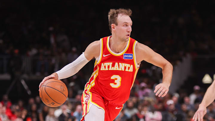 Oct 22, 2025; Atlanta, Georgia, USA; Atlanta Hawks guard Luke Kennard (3) drives on Toronto Raptors forward Jamison Battle (77) in the second quarter at State Farm Arena. Mandatory Credit: Brett Davis-Imagn Images
