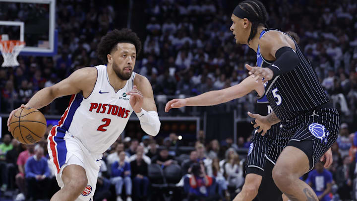 Apr 19, 2026; Detroit, Michigan, USA; Detroit Pistons guard Cade Cunningham (2) dribbles defended by Orlando Magic forward Paolo Banchero (5) in the second half during the 2026 NBA Playoffs at Little Caesars Arena.