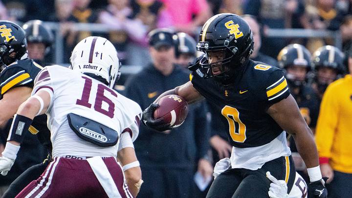 Southeast Polk's Stanley Cooper (0) looks to shake off his defender, Dowling Catholic's Grayson Pennington (23), on Sept. 18, 2026, at Southeast Polk High School.