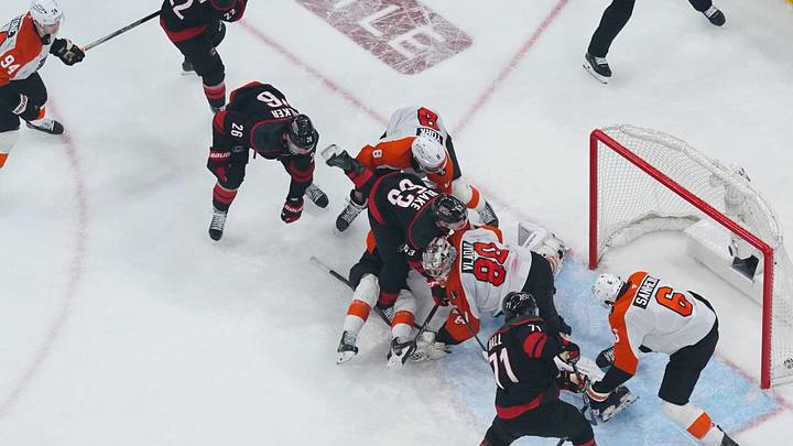 May 4, 2026; Raleigh, North Carolina, USA; Carolina Hurricanes left wing Taylor Hall (71) scores the game winning goal past Philadelphia Flyers goaltender Dan Vladar (80) and defenseman Travis Sanheim (6) during the first overtime in game two of the second round of the 2026 Stanley Cup Playoffs at Lenovo Center. Mandatory Credit: James Guillory-Imagn Images