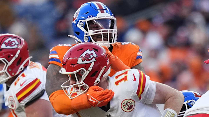 Jan 5, 2025; Denver, Colorado, USA; Denver Broncos defensive end John Franklin-Myers (98) hits Kansas City Chiefs quarterback Carson Wentz (11) in the second half at Empower Field at Mile High. Jan 5, 2025; Denver, Colorado, USA; Denver Broncos defensive end John Franklin-Myers (98) hits Kansas City Chiefs quarterback Carson Wentz (11) in the second half at Empower Field at Mile High.