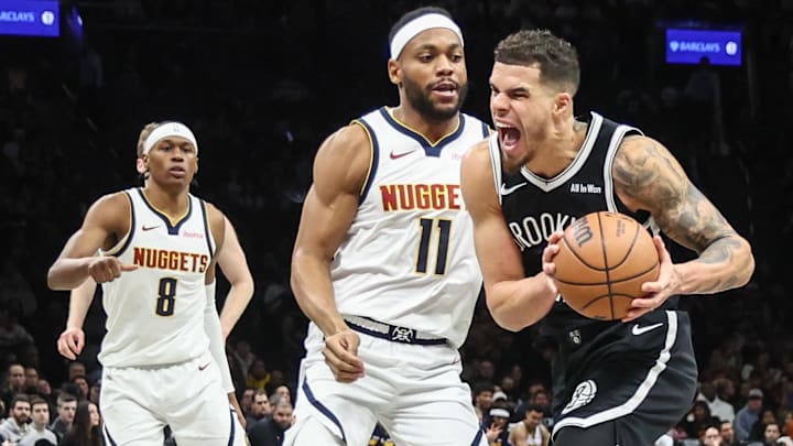 Jan 4, 2026; Brooklyn, New York, USA;  Brooklyn Nets forward Michael Porter Jr. (17) looks to drive past Denver Nuggets guard Bruce Brown (11) in the third quarter at Barclays Center. Mandatory Credit: Wendell Cruz-Imagn Images