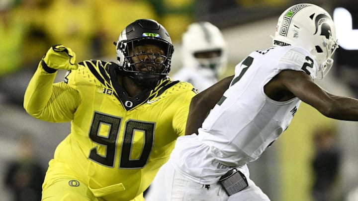 Oct 4, 2024; Eugene, Oregon, USA; Oregon Ducks defensive lineman Jamaree Caldwell (90) chases after Michigan State Spartans quarterback Aidan Chiles (2) during the second half at Autzen Stadium. Mandatory Credit: Troy Wayrynen-Imagn Images
