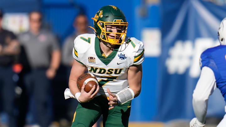 Jan 8, 2023; Frisco, Texas, US; North Dakota State Bison quarterback Cam Miller (7) runs the ball against South Dakota State Jackrabbits defensive tackle Caleb Sanders (99) during the second half of the DI Football Championship at Toyota Stadium. Mandatory Credit: Chris Jones-Imagn Images Jan 8, 2023; Frisco, Texas, US; North Dakota State Bison quarterback Cam Miller (7) runs the ball against South Dakota State Jackrabbits defensive tackle Caleb Sanders (99) during the second half of the DI Football Championship at Toyota Stadium. Mandatory Credit: Chris Jones-Imagn Images