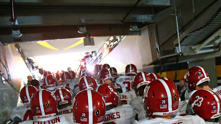 Jan 11, 2016; Glendale, AZ, USA; Alabama Crimson Tide players enter the field through the tunnel prior to the game against the Clemson Tigers in the 2016 CFP National Championship at University of Phoenix Stadium. Mandatory Credit: Mark J. Rebilas-Imagn Images