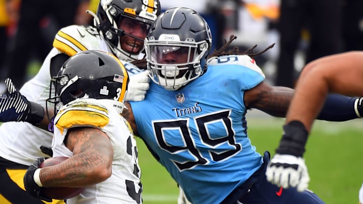 Oct 25, 2020; Nashville, Tennessee, USA; Tennessee Titans outside linebacker Jadeveon Clowney (99) tackles Pittsburgh Steelers running back James Conner (30) at Nissan Stadium. Mandatory Credit: Christopher Hanewinckel-Imagn Images