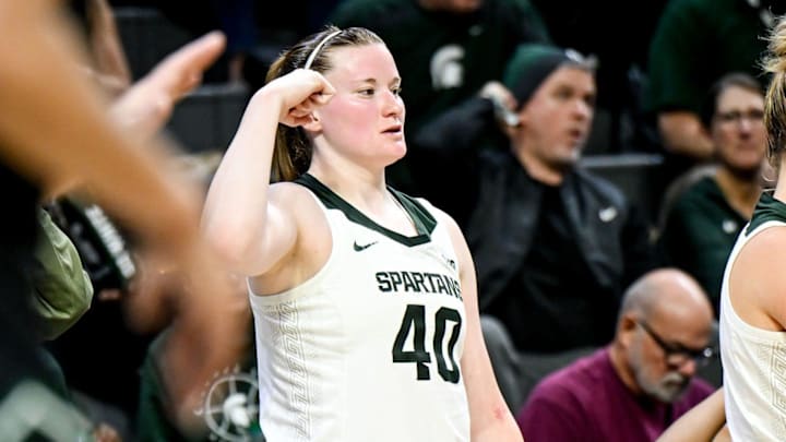 Michigan State's Julia Ayrault, left, and Theryn Hallock celebrate a Spartans score against Eastern Michigan during the third quarter on Monday, Nov. 11, 2024, in East Lansing.