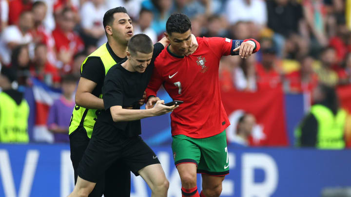 Six fans stormed the pitch for a picture with Cristiano Ronaldo when Portugal faced Turkey