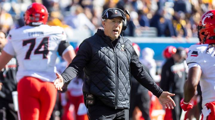 Oct 17, 2026; Morgantown, West Virginia, USA;  Cincinnati Bearcats head coach Scott Satterfield celebrates with players during the third quarter against the West Virginia Mountaineers at Milan Puskar Stadium.  Mandatory Credit: Ben Queen-Imagn Images