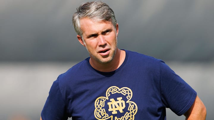 Notre Dame quarterbacks coach Gino Guidugli watches players warm up during a Notre Dame football practice at Irish Athletic Center on Tuesday, Aug. 6, 2024, in South Bend. Notre Dame quarterbacks coach Gino Guidugli watches players warm up during a Notre Dame football practice at Irish Athletic Center on Tuesday, Aug. 6, 2024, in South Bend.