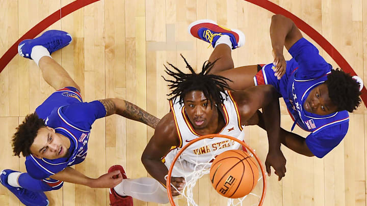 Iowa State Cyclones guard Demarion Watson (4) shoots the ball between Kansas Jayhawks guard Zeke Mayo (5) and forward Flory Bidunga (40)during the first half in the Big-12 men’s basketball showdown at Hilton Coliseum on Wednesday, Jan. 15, 2025 in Ames, Iowa.