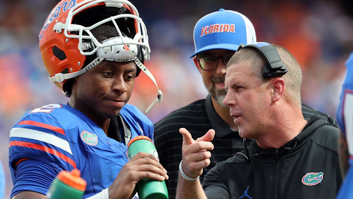 Sep 6, 2025; Gainesville, Florida, USA; Florida Gators head coach Billy Napier talks with Florida Gators quarterback DJ Lagway (2) against the South Florida Bulls during the first quarter at Ben Hill Griffin Stadium. Mandatory Credit: Kim Klement Neitzel-Imagn Images