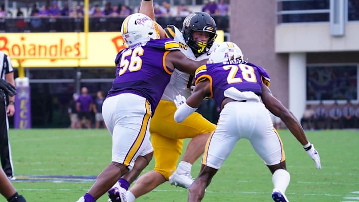 East Carolina Pirates DL D'Anta Johnson and defensive back Shavon Revel Jr. stop the run by Appalachian State Mountaineers RB Anderson Castle. East Carolina Pirates DL D'Anta Johnson and defensive back Shavon Revel Jr. stop the run by Appalachian State Mountaineers RB Anderson Castle.