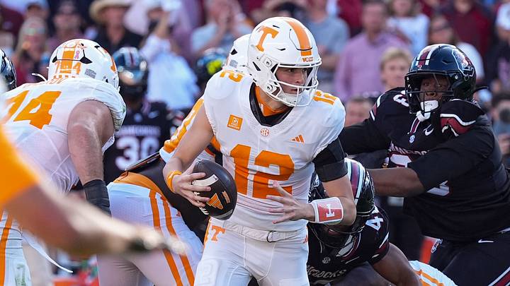 Oct 24, 2026; Columbia, South Carolina, USA;  Tennessee Volunteers quarterback George MacIntyre (12) is forced to run out of the pocket against the South Carolina Gamecocks during the first half at Williams-Brice Stadium.  Mandatory Credit: Jim Dedmon-Imagn Images