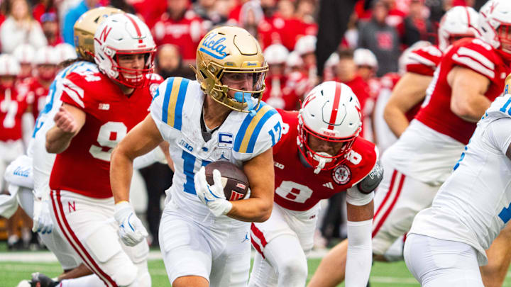 Nov 2, 2024; Lincoln, Nebraska, USA; UCLA Bruins wide receiver Logan Loya (17) returns a punt against Nebraska Cornhuskers defensive back DeShon Singleton (8) and defensive back Jeremiah Charles (25) during the second quarter at Memorial Stadium. Mandatory Credit: Dylan Widger-Imagn Images Nov 2, 2024; Lincoln, Nebraska, USA; UCLA Bruins wide receiver Logan Loya (17) returns a punt against Nebraska Cornhuskers defensive back DeShon Singleton (8) and defensive back Jeremiah Charles (25) during the second quarter at Memorial Stadium. Mandatory Credit: Dylan Widger-Imagn Images