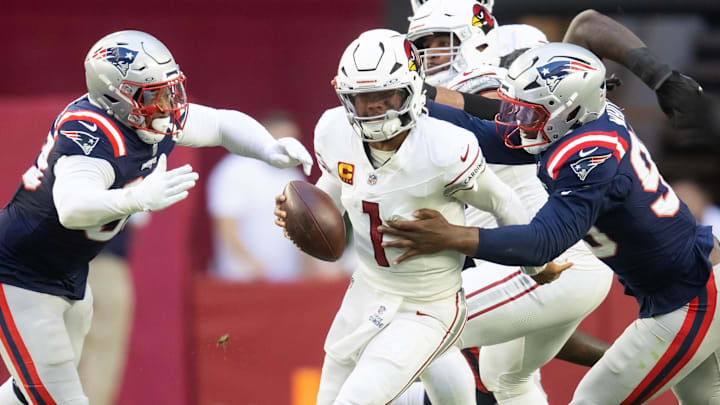 Dec 15, 2024; Glendale, Arizona, USA; Arizona Cardinals quarterback Kyler Murray (1) is sacked by New England Patriots defensive end Keion White (99) and linebacker Anfernee Jennings (33) in the first half at State Farm Stadium. Mandatory Credit: Mark J. Rebilas-Imagn Images