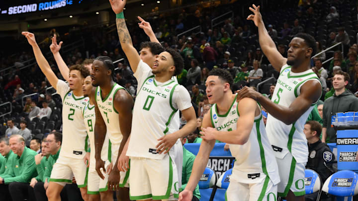 Mar 21, 2025; Seattle, WA, USA; Oregon Ducks guard Jadrian Tracey (2),forward Supreme Cook (7), guard Ra'Heim Moss (0), guard TJ Bamba (5) react from the bench against the Liberty Flames during the second half in the first round of the NCAA Tournament at Climate Pledge Arena. Mandatory Credit: Steven Bisig-Imagn Images