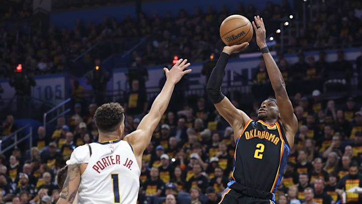 May 5, 2025; Oklahoma City, Oklahoma, USA; Oklahoma City Thunder guard Shai Gilgeous-Alexander (2) shoots against Denver Nuggets forward Michael Porter Jr. (1) during the second half in game one of the second round for the 2025 NBA Playoffs at Paycom Center. Mandatory Credit: Alonzo Adams-Imagn Images