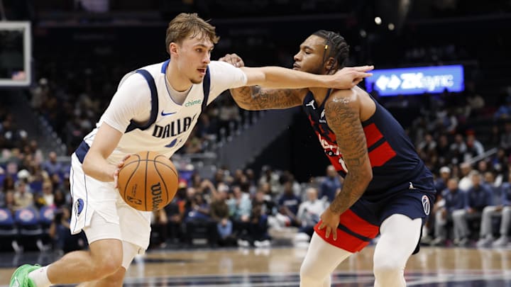 Nov 8, 2025; Washington, District of Columbia, USA; Dallas Mavericks forward Cooper Flagg (32) drives to the basket as Washington Wizards forward Cam Whitmore (1) defends in the first half at Capital One Arena. Mandatory Credit: Geoff Burke-Imagn Images