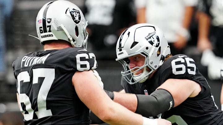 Oct 12, 2025; Paradise, Nevada, USA; Las Vegas Raiders guard Alex Cappa (65) and Las Vegas Raiders center Will Putnam (67) warm up before the game against the Tennessee Titans at Allegiant Stadium. Mandatory Credit: Stephen R. Sylvanie-Imagn Images