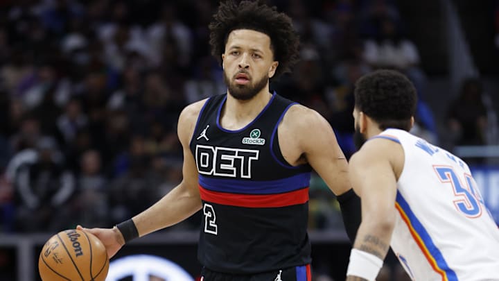 Mar 15, 2025; Detroit, Michigan, USA;  Detroit Pistons guard Cade Cunningham (2) dribbles defended by Oklahoma City Thunder forward Kenrich Williams (34) in the first half at Little Caesars Arena. Mandatory Credit: Rick Osentoski-Imagn Images