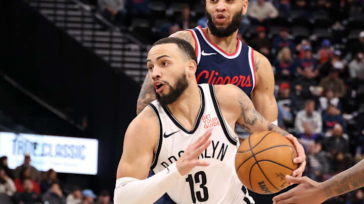 Jan 15, 2025; Inglewood, California, USA;  Brooklyn Nets guard Tyrese Martin (13) dribbles between LA Clippers guard Amir Coffey (7) and guard Bones Hyland (5) during the fourth quarter at Intuit Dome. Mandatory Credit: Kiyoshi Mio-Imagn Images