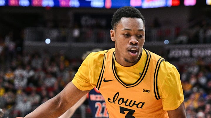 Dec 20, 2025; Iowa City, Iowa, USA; Iowa Hawkeyes forward Cam Manyawu (3) controls the ball as Bucknell Bison forward Grgur Brcic (23) defends during the second half at Casey’s Center. Mandatory Credit: Jeffrey Becker-Imagn Images